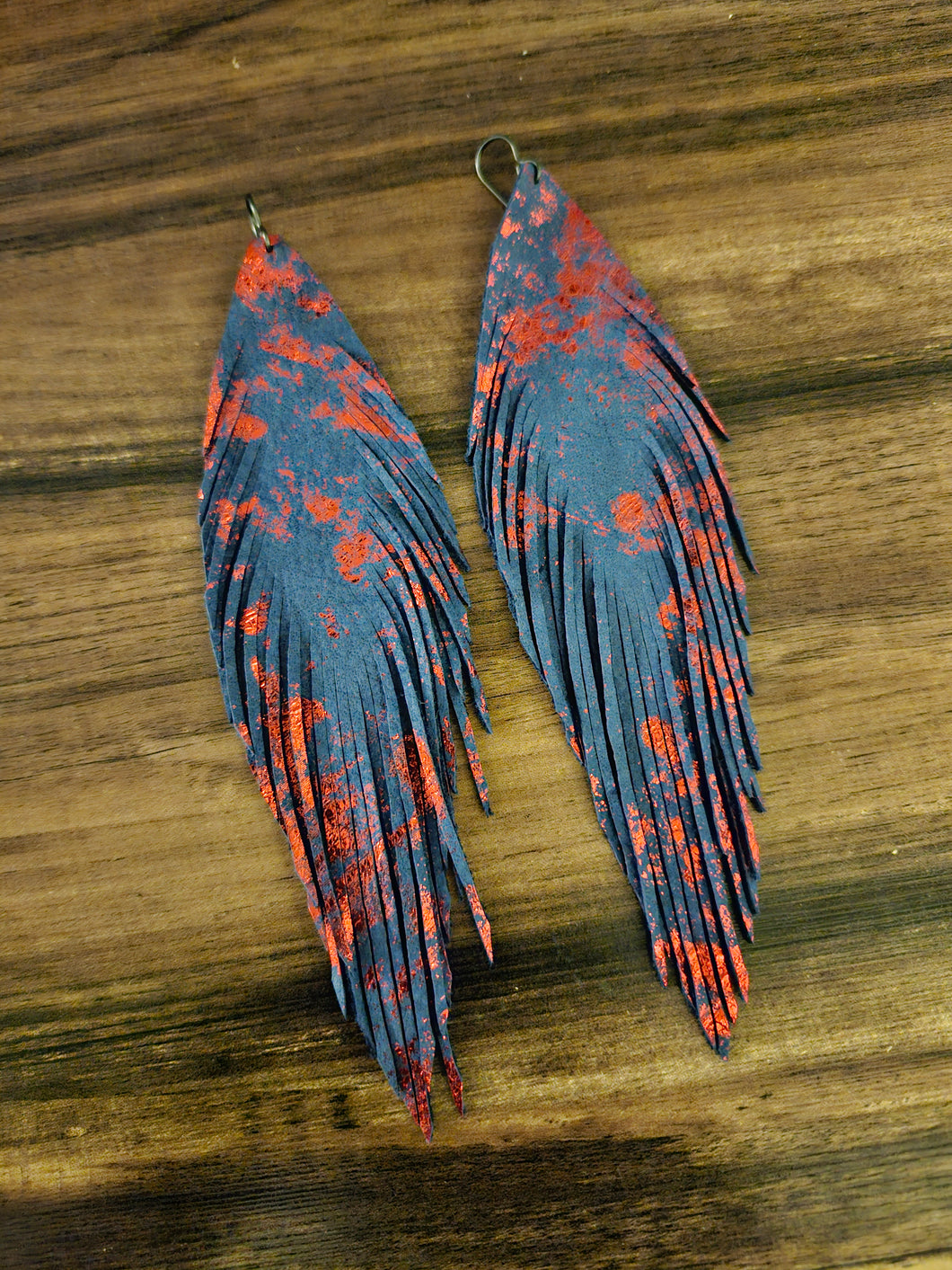 Navy blue feather with metallic red splash